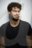 Grimacing young Man wearing a dark T-Shirt