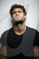 Grimacing young Man wearing a dark T-Shirt
