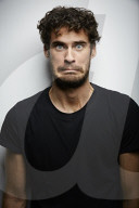 Grimacing young Man wearing a dark T-Shirt