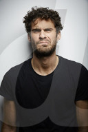 Grimacing young Man wearing a dark T-Shirt
