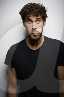 Grimacing young Man wearing a dark T-Shirt