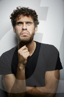 Grimacing young Man wearing a dark T-Shirt