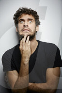 Grimacing young Man wearing a dark T-Shirt