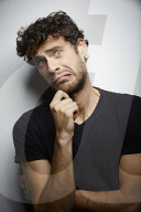 Grimacing young Man wearing a dark T-Shirt