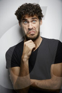 Grimacing young Man wearing a dark T-Shirt