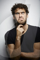 Grimacing young Man wearing a dark T-Shirt