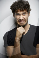 Grimacing young Man wearing a dark T-Shirt
