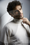 Young Man wearing a white Turtleneck