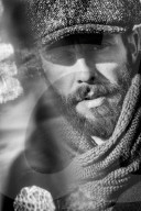 Portrait of a Man wearing Flat Cap and Scarf