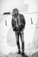 Lonesome Man at the Beach wearing a hooded Jacket