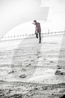 Lonesome Man at the Beach kicking Stones