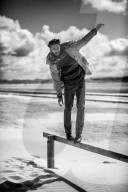 Lonesome Man at the Beach balances on Balustrade