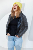 Portrait of a Woman with curly Hair wearing a yellow Beanie