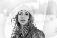 Portrait of a Woman with curly Hair wearing a yellow Beanie