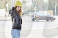 Portrait of a Woman with curly Hair wearing a yellow Beanie