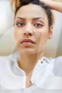 Portrait of a thoughtful Woman with curly Hair 