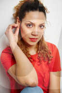 Portrait of a Woman with curly Hair wearing a red T-Shirt
