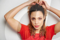 Portrait of a Woman with curly Hair wearing a red T-Shirt