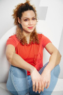 Portrait of a Woman with curly Hair wearing a red T-Shirt