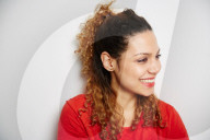 Portrait of a Woman with curly Hair wearing a red T-Shirt