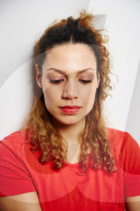 Portrait of a Woman with curly Hair wearing a red T-Shirt