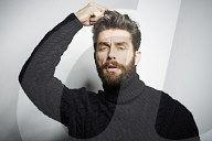 Portrait of a Man wearing a black Turtleneck