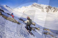Couple skiiing downhill
