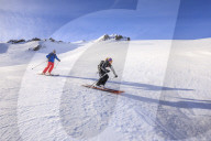 Couple skiiing downhill