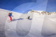 Couple skiiing downhill
