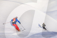 Couple skiiing downhill