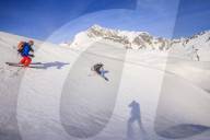 Couple skiiing downhill
