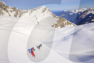 Couple skiiing downhill