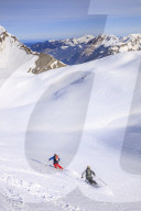 Couple skiiing downhill