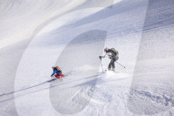 Couple skiiing downhill