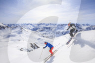 Couple skiing downhill