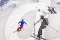 Couple skiing downhill