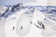 Couple skiing downhill