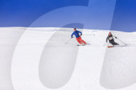 Couple skiing downhill