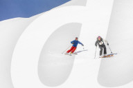 Couple skiing downhill