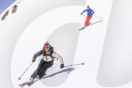 Couple skiing downhill