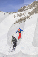 Couple skiiing downhill
