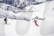 Couple skiiing downhill