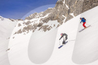 Couple skiiing downhill