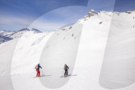 Couple skiiing downhill