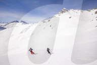 Couple skiiing downhill