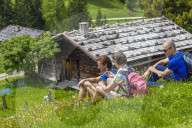 Two Women and a Man resting during a Hiking Tour