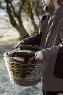 Wabi-Sabi Living Concept, Man carries a Basket full of Firewood
