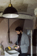 Wabi-Sabi Living Concept, Man uses the Vegetable Brush to clean a Pumpkin 