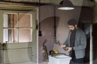 Wabi-Sabi Living Concept, Man uses the Vegetable Brush to clean a Pumpkin 