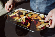 Man holding a Casserole Dish with mixed Vegetables